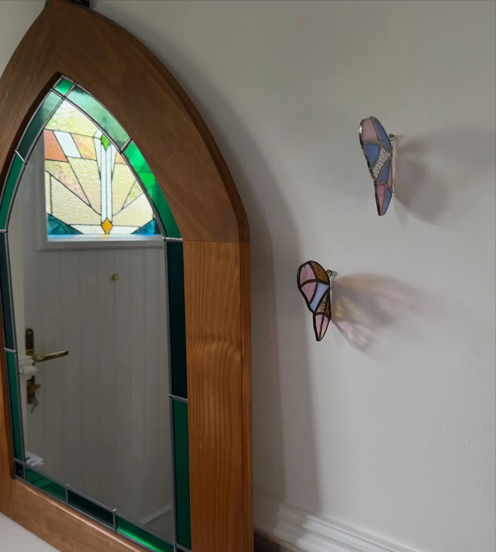 Stained glass archway mirror and wall butterflies